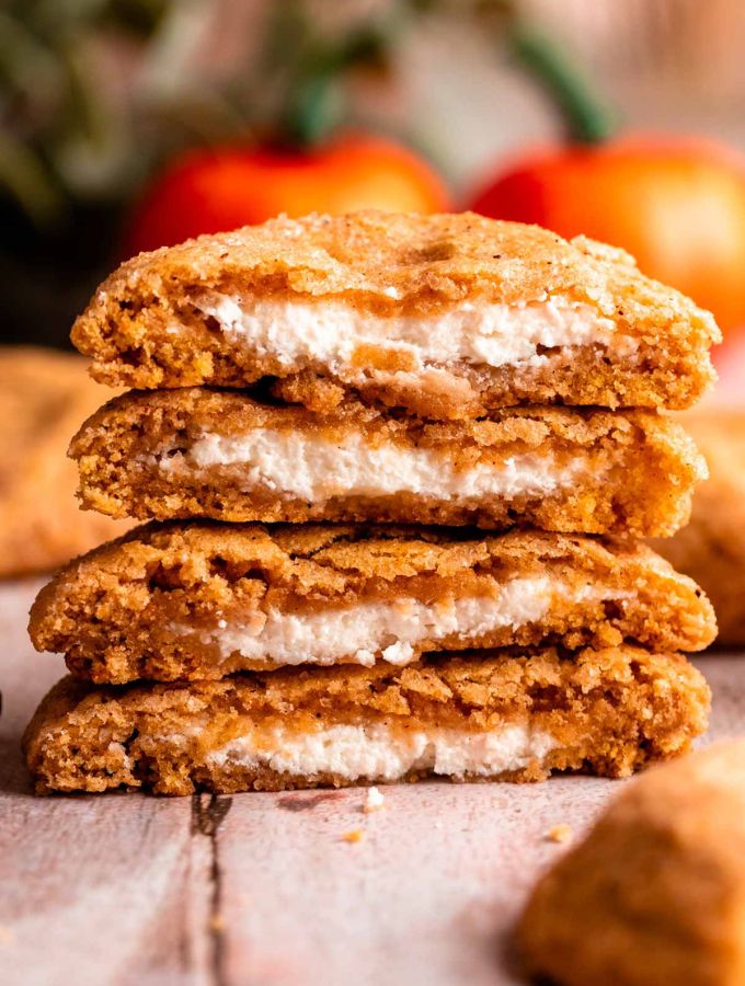 Stack of pumpkin cheesecake cookies cut in half.