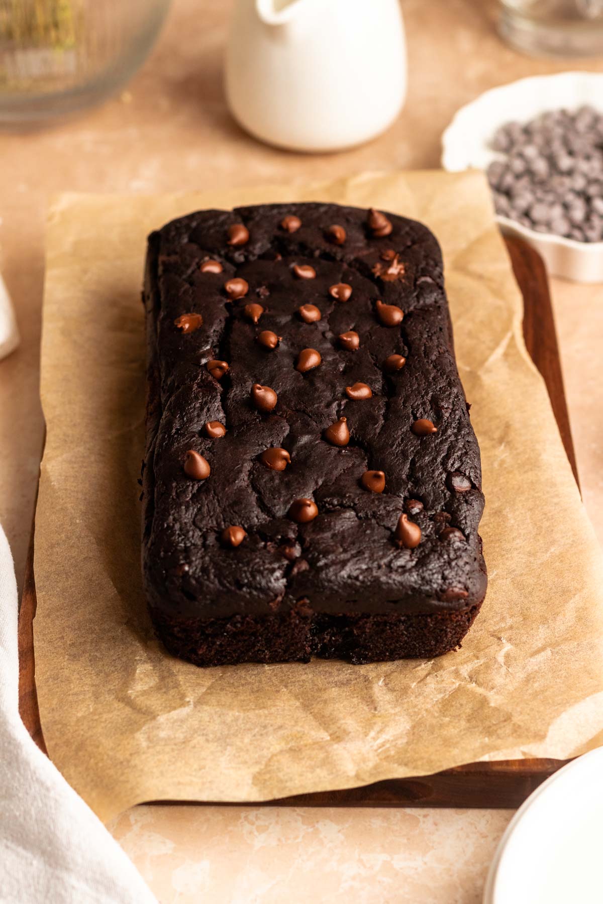 Loaf of chocolate pumpkin bread on a parchment paper.