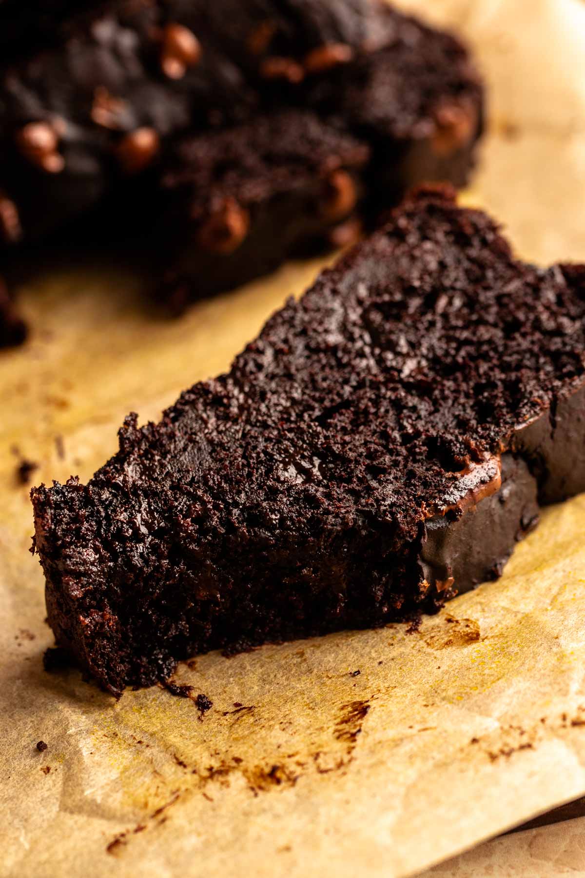 Slice of chocolate pumpkin bread with a bite missing.