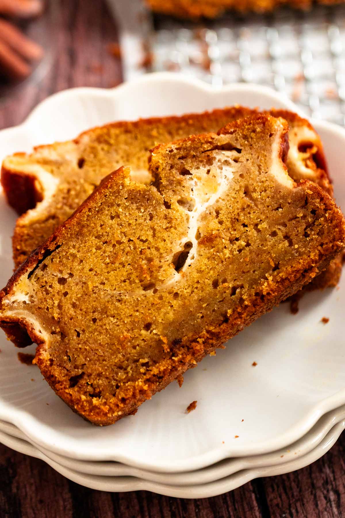 Close up shot of two slices of cream cheese pumpkin bread.