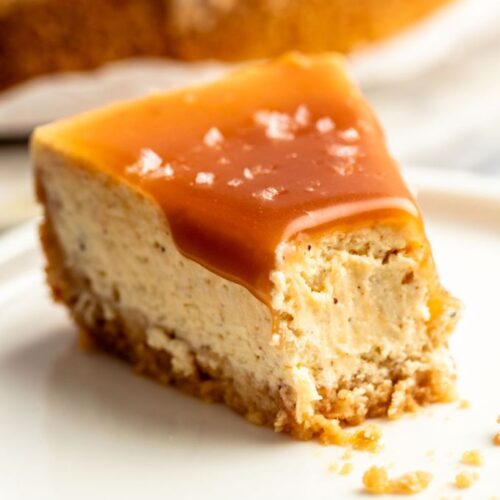Slice of salted caramel cheesecake with a bite missing.