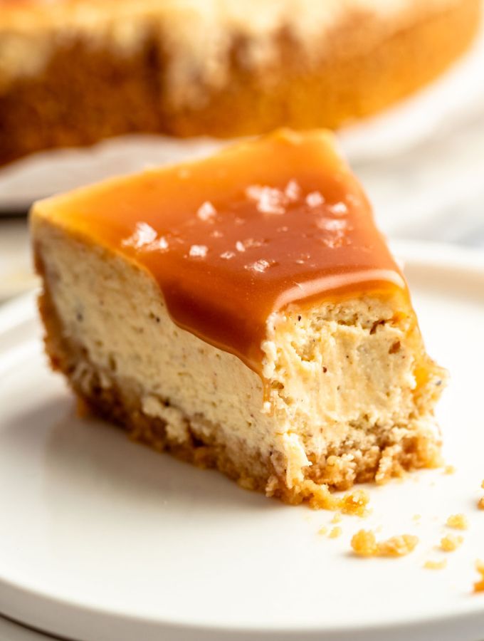 Slice of salted caramel cheesecake with a bite missing.