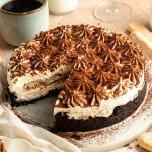 Slice missing from a tiramisu cheesecake.