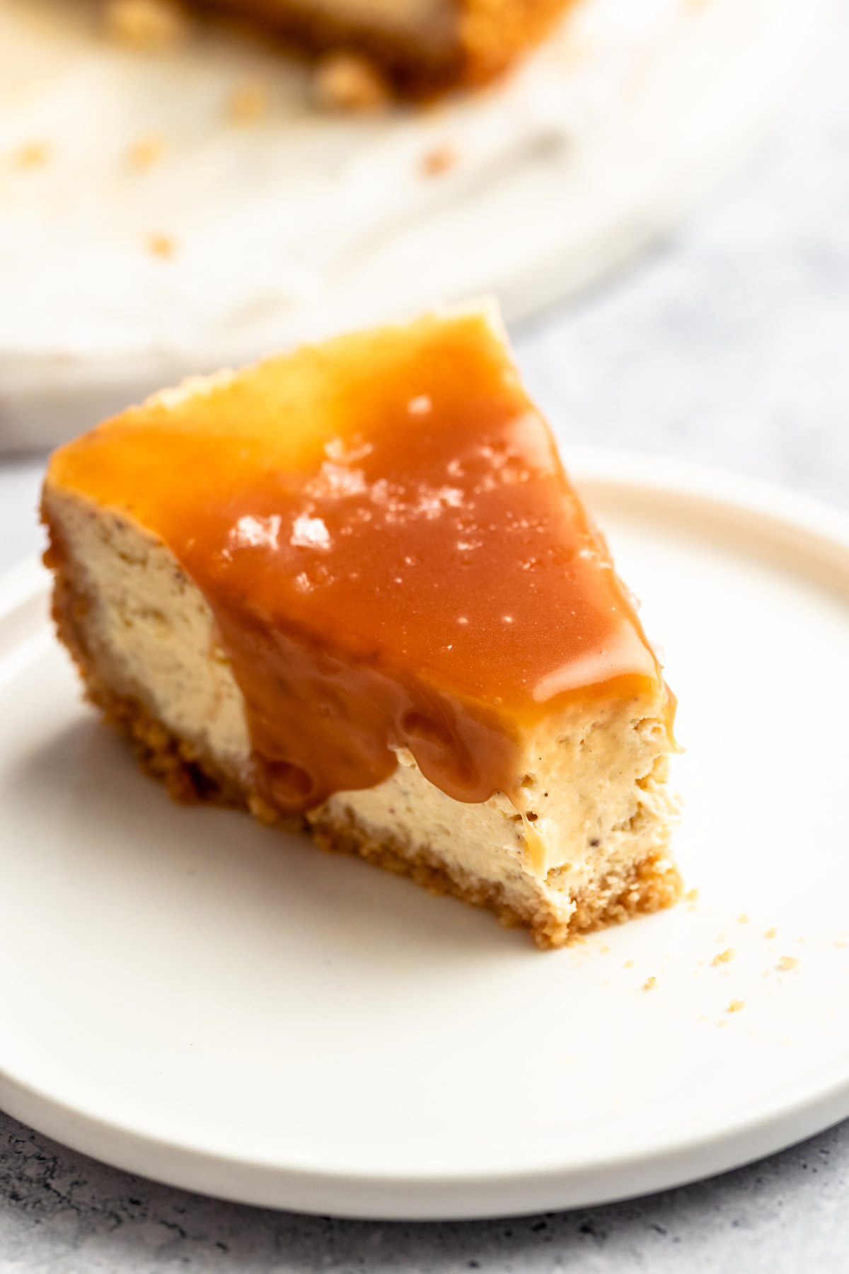 Slice of salted caramel cheesecake with a bite missing.