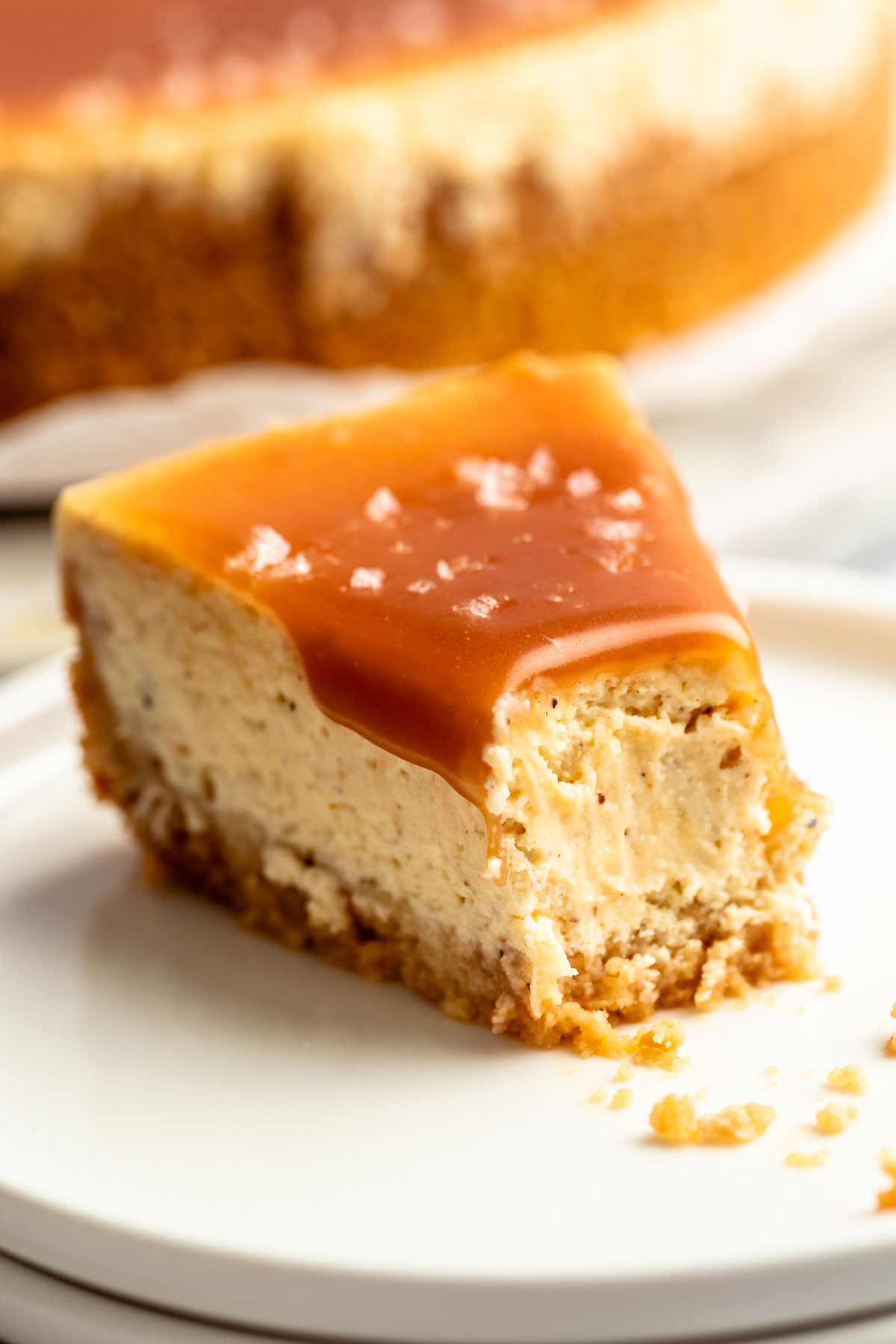 Slice of salted caramel cheesecake with a bite missing.