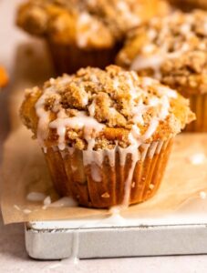 Close up shot of cinnamon streusel muffins with glaze.