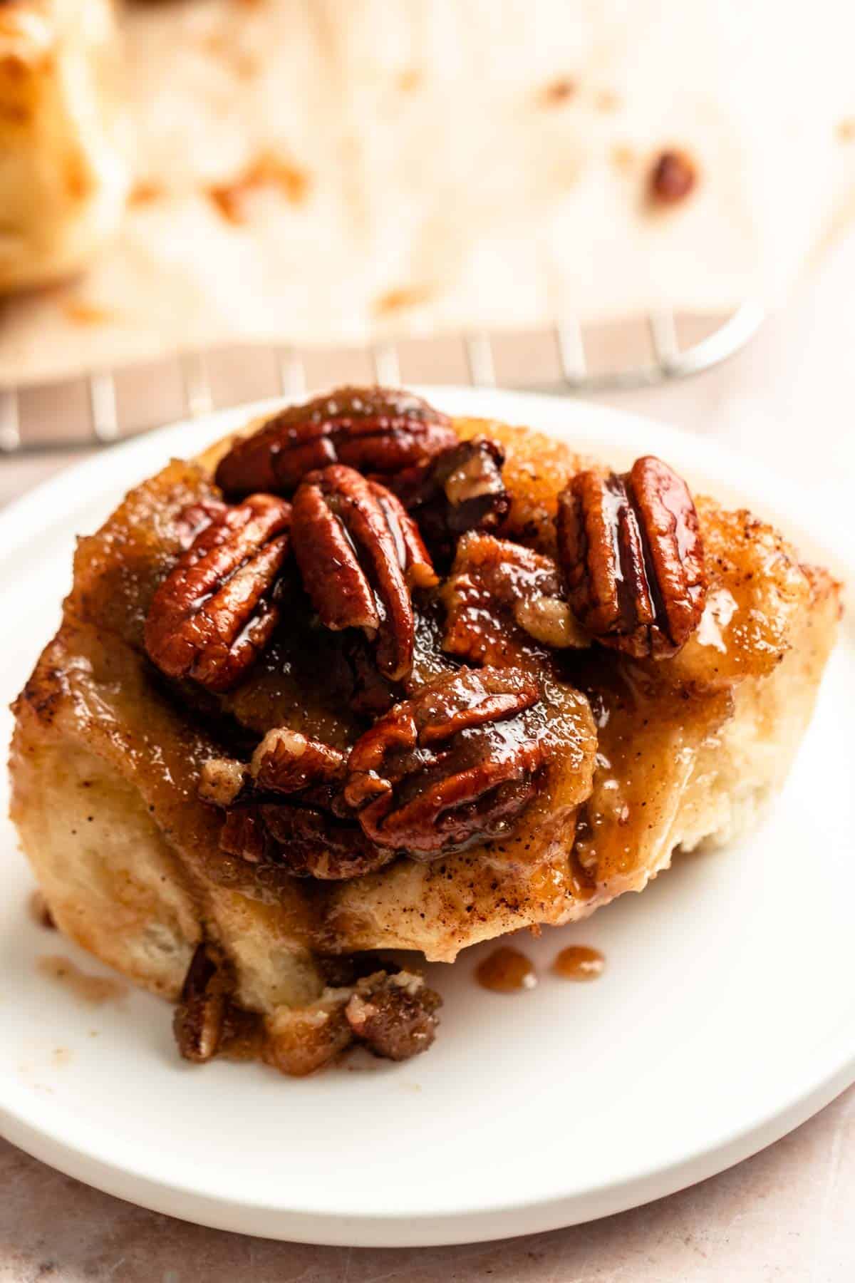 Pecan sticky buns on a white plate.