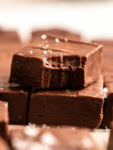Stack of two 2 ingredient fudge with the top one missing a bite.