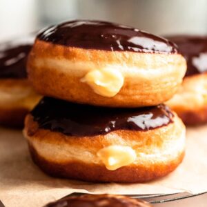 Stack of two Boston cream donuts.