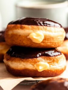 Stack of two Boston cream donuts.