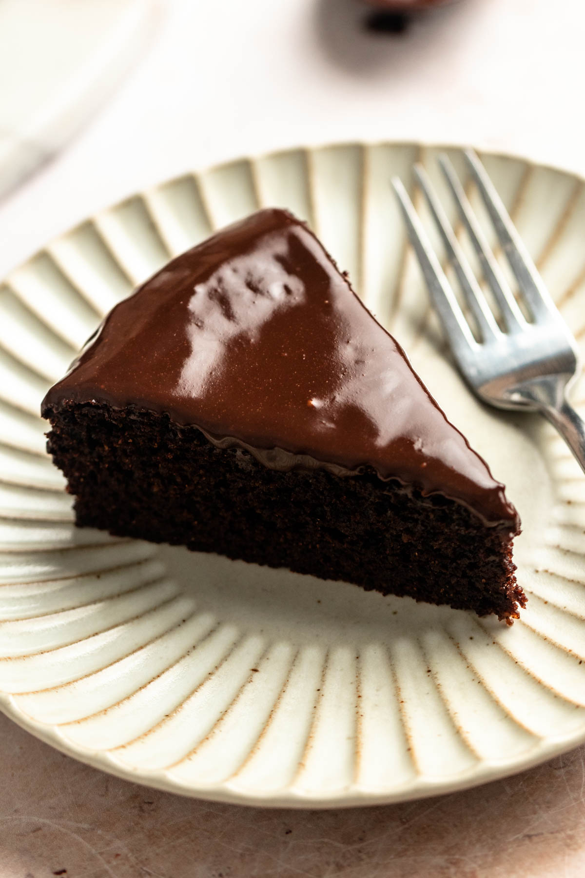Slice of almond flour chocolate cake on a plate.