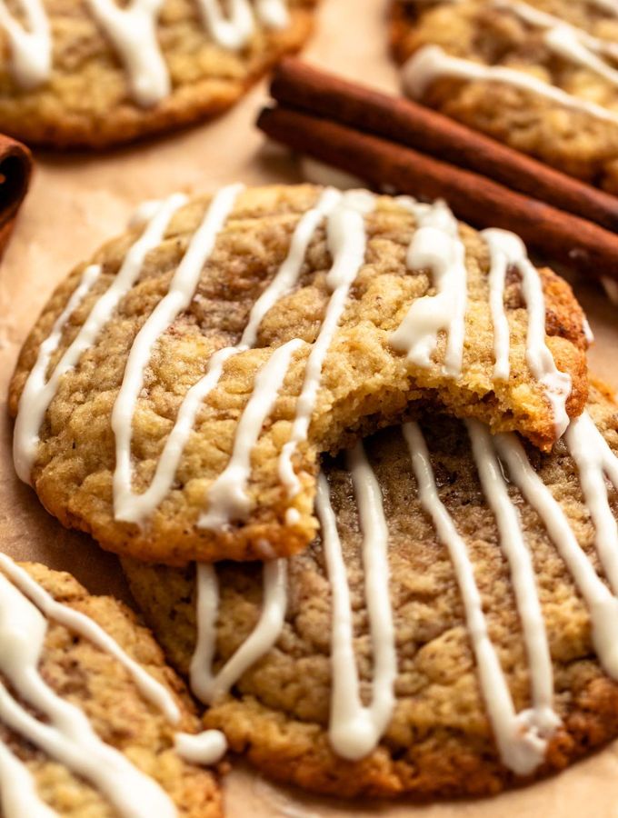 Two cinnamon roll cookies with cream cheese glaze on top.