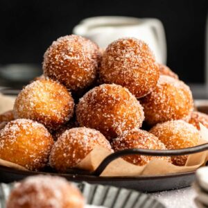 Stack of donut holes on a plate.