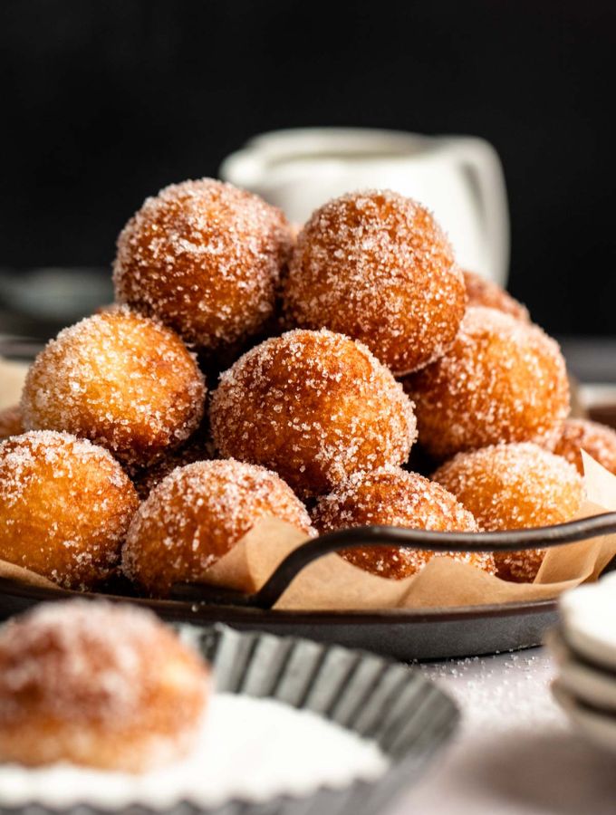 Stack of donut holes on a plate.