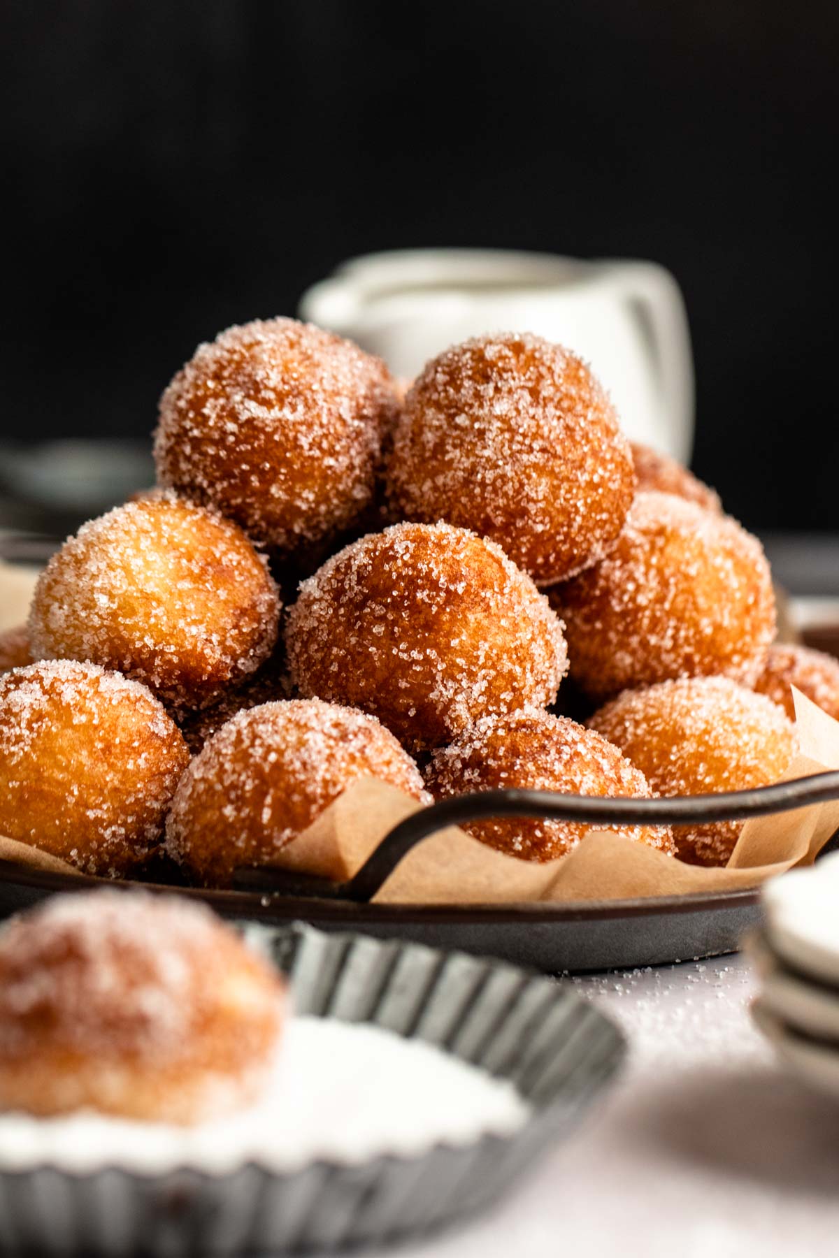 Stack of donut holes on a plate.