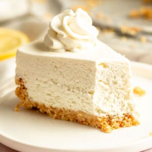 Slice of Philadelphia no bake cheesecake with cool whip with a bite missing.