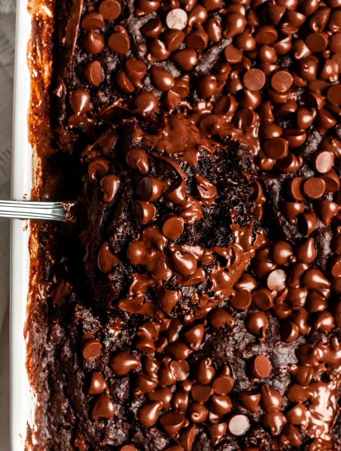 Close up shot of chocolate dump cake with chocolate chips on top.