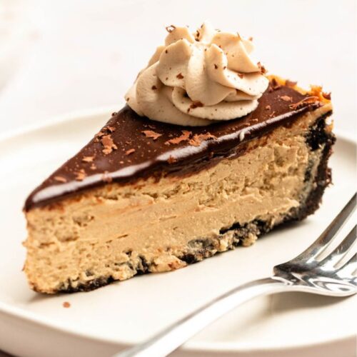 Slice of coffee cheesecake on a white plate.