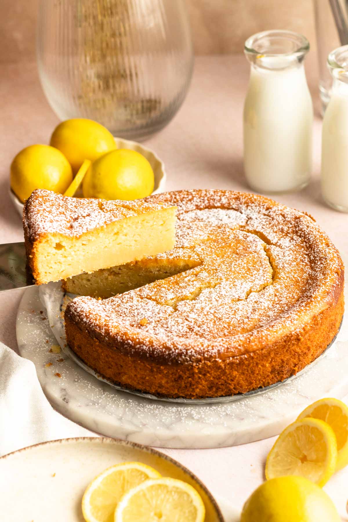 Slice of lemon ricotta cake pulled away from the cake.