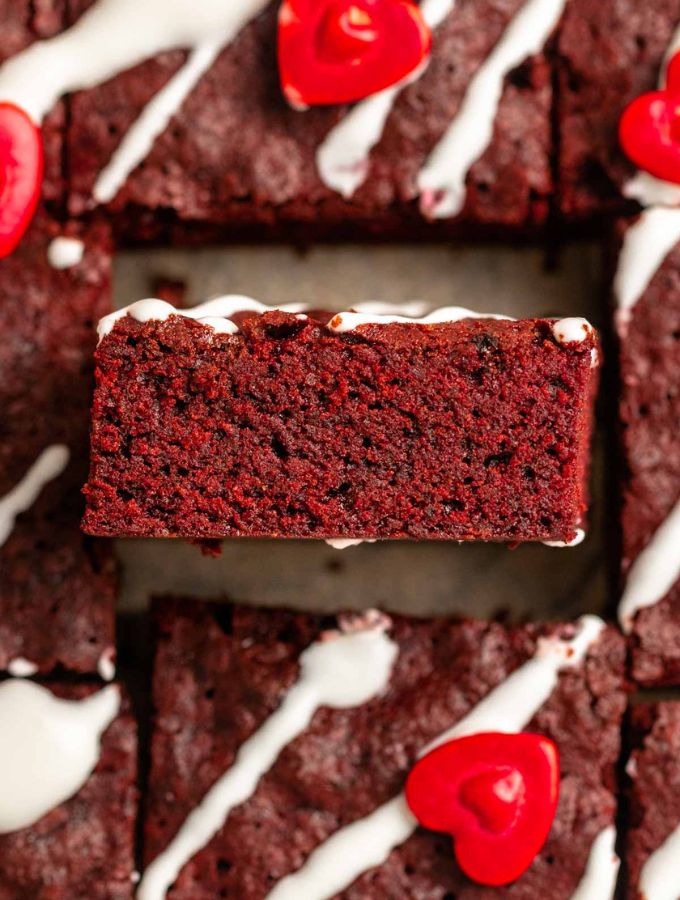 Top of red velvet brownies with a cream cheese glaze.