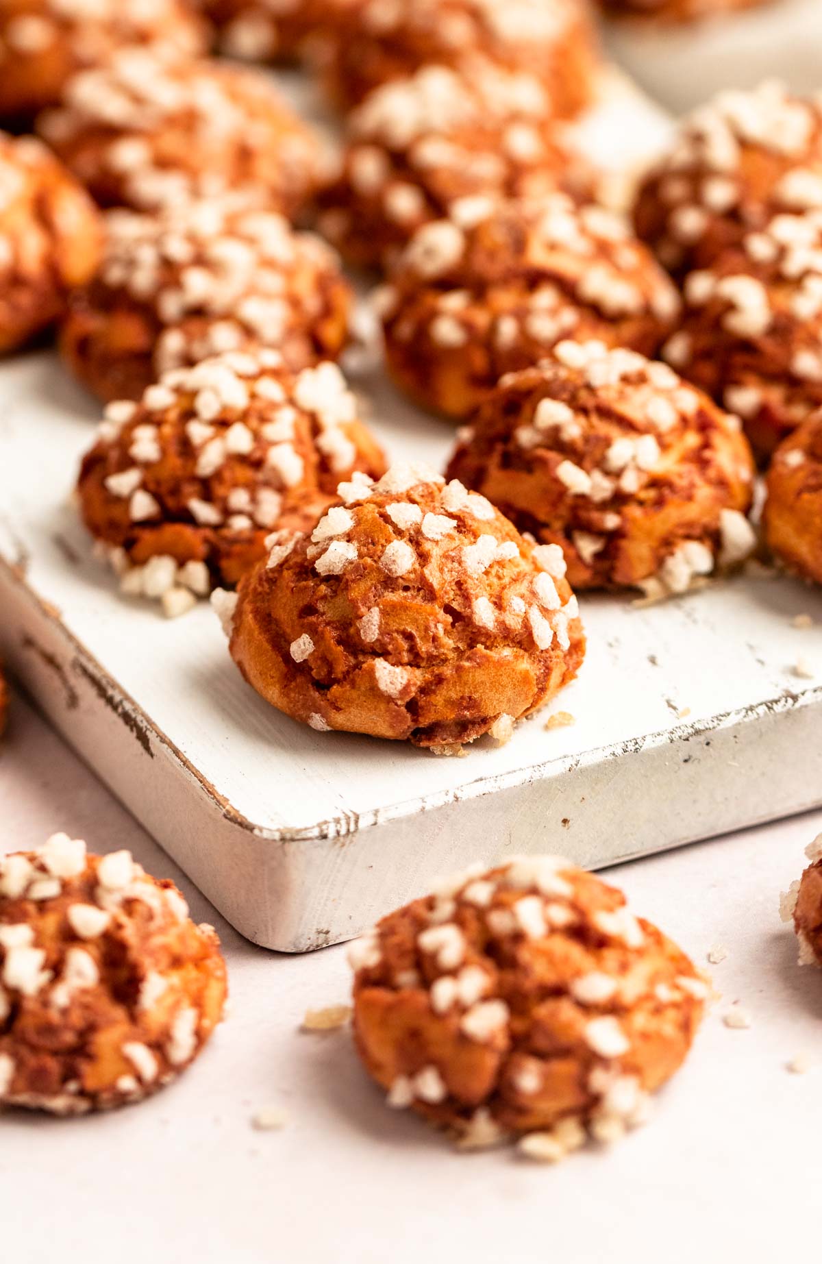 Pile of chouqettes on a wooden board.