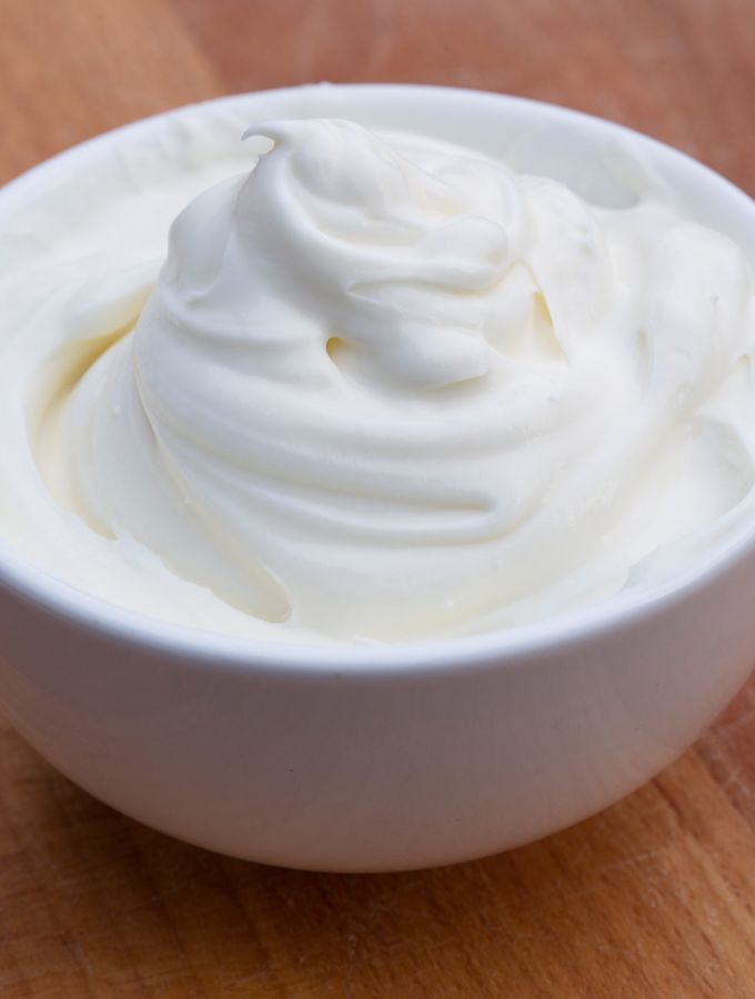 Close up shot of a bowl with heavy cream.