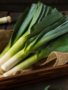 Leeks in a wooden bowl.
