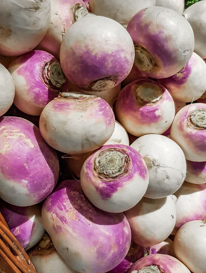 Pile of rutabaga with a hard sunlight.