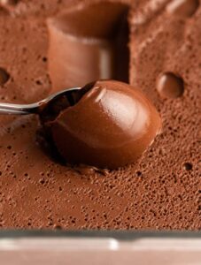 Spoon scooping out chocolate cremaux.