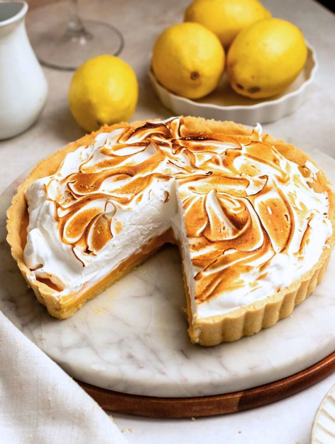 Slice missing from a lemon meringue tart.