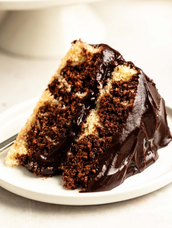 Slice of chocolate marble cake on a white plate.