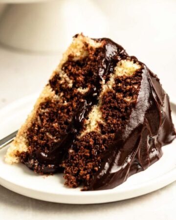 Slice of chocolate marble cake on a white plate.