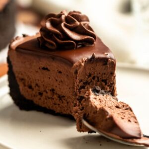 Bite missing from a slice of a no-bake chocolate cheesecake.