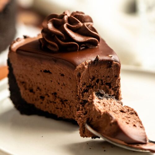 Bite missing from a slice of a no-bake chocolate cheesecake.