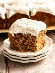 Slice of apple spice cake with a bite missing.
