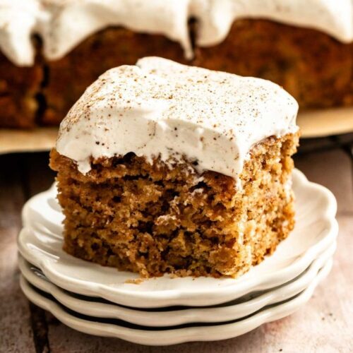 Slice of apple spice cake with a bite missing.