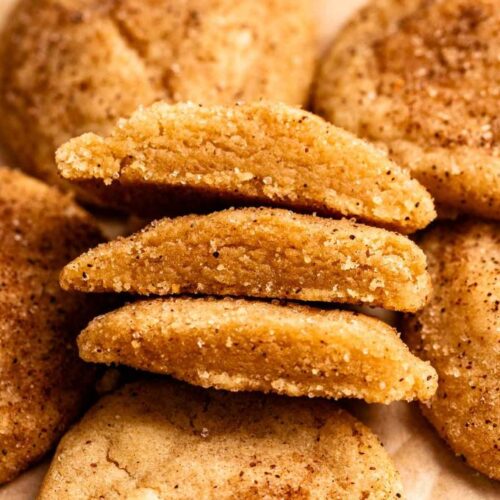 Two brown butter snickerdoodle cookies cut in half.
