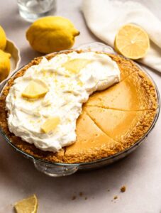 Close up shot of lemon pie with condensed milk with whipped cream on top.