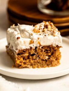 Slice of pumpkin tres leches cake on a white plate.