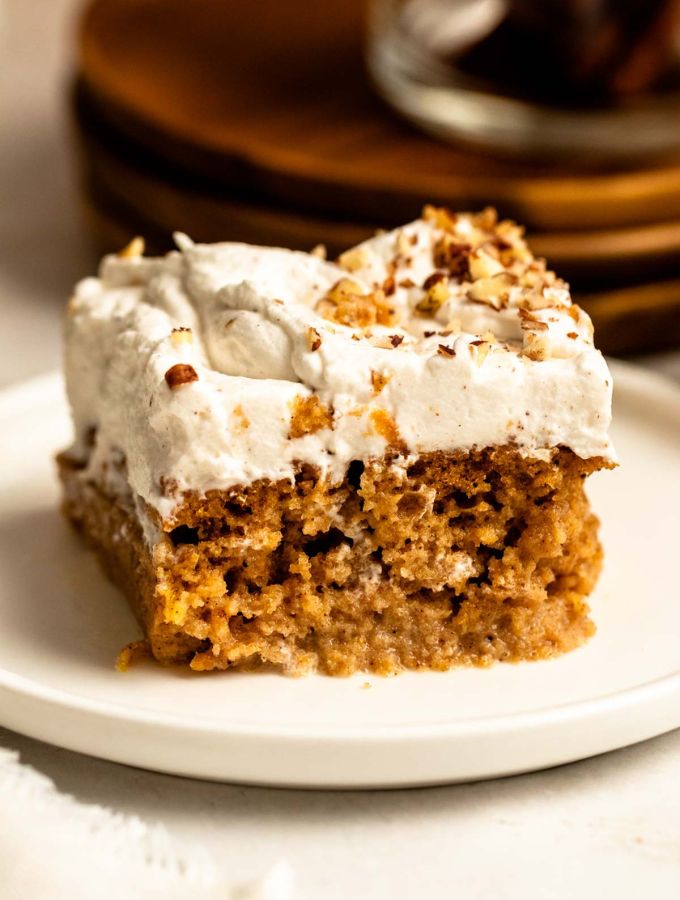 Slice of pumpkin tres leches cake on a white plate.