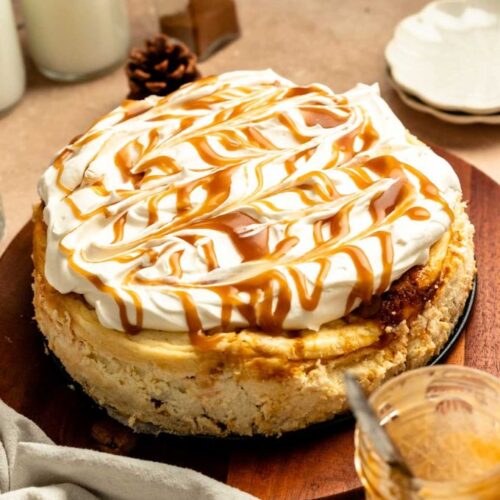 Pumpkin cake cheesecake on a wooden plate.