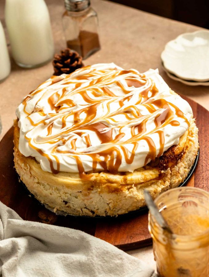 Pumpkin cake cheesecake on a wooden plate.