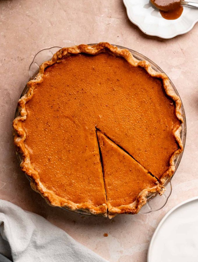 Top of a sweet potato pie with condensed milk with one slice sliced.