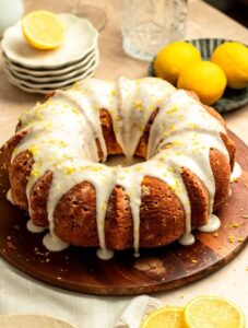 Lemon cream cheese pound cake on a wood plate.