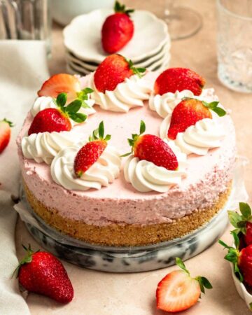 Strawberry mousse cake on a cake plate.