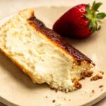 Bite missing from a slice of loaf pan basque cheesecake.