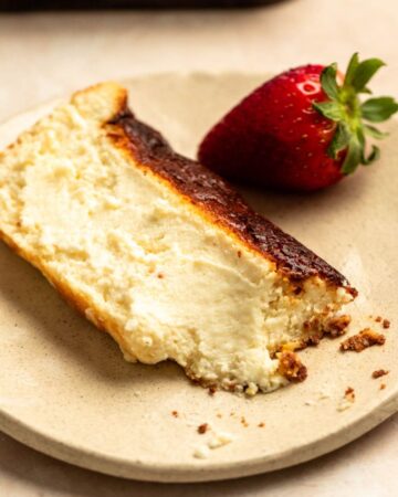 Bite missing from a slice of loaf pan basque cheesecake.