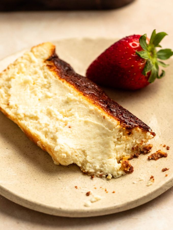Bite missing from a slice of loaf pan basque cheesecake.