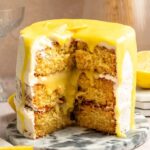 Slice missing from a lemon curd cake.