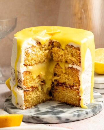 Slice missing from a lemon curd cake.